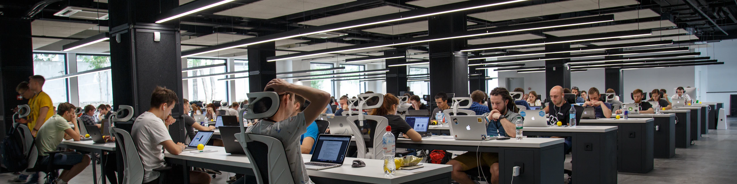 Large operations floor with analysts working at their monitors