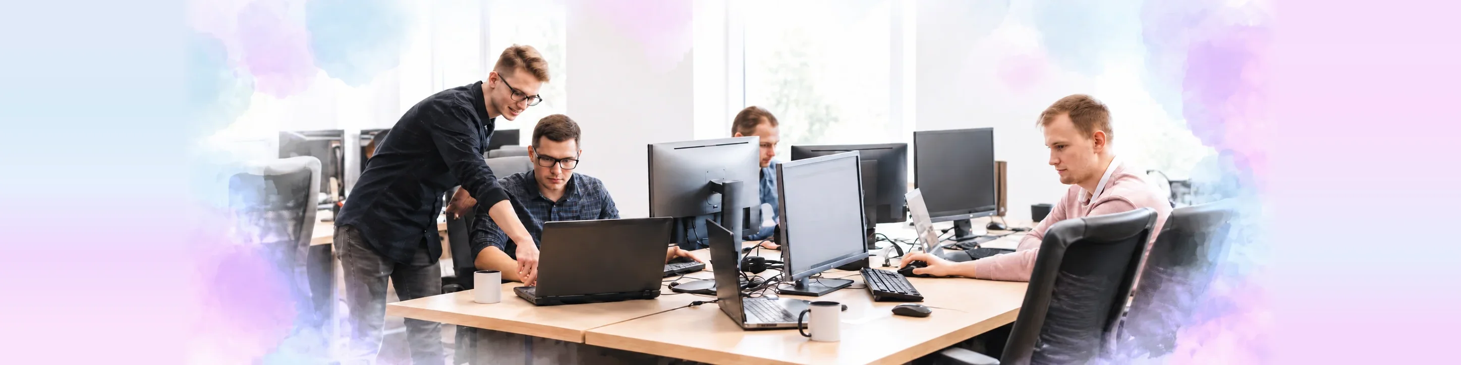 Software engineers collaborating at workstations in an open office