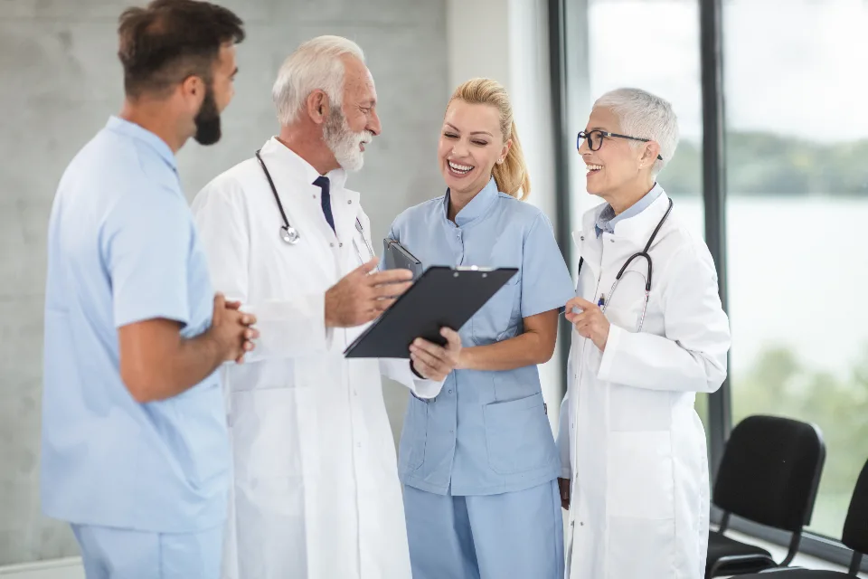 Doctors and nurses reviewing patient information together