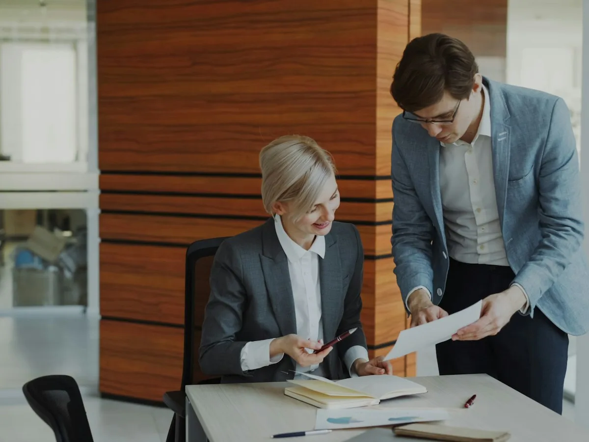 Two professionals reviewing documents in a modern law office